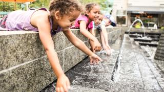 Kids playing in a fountain.