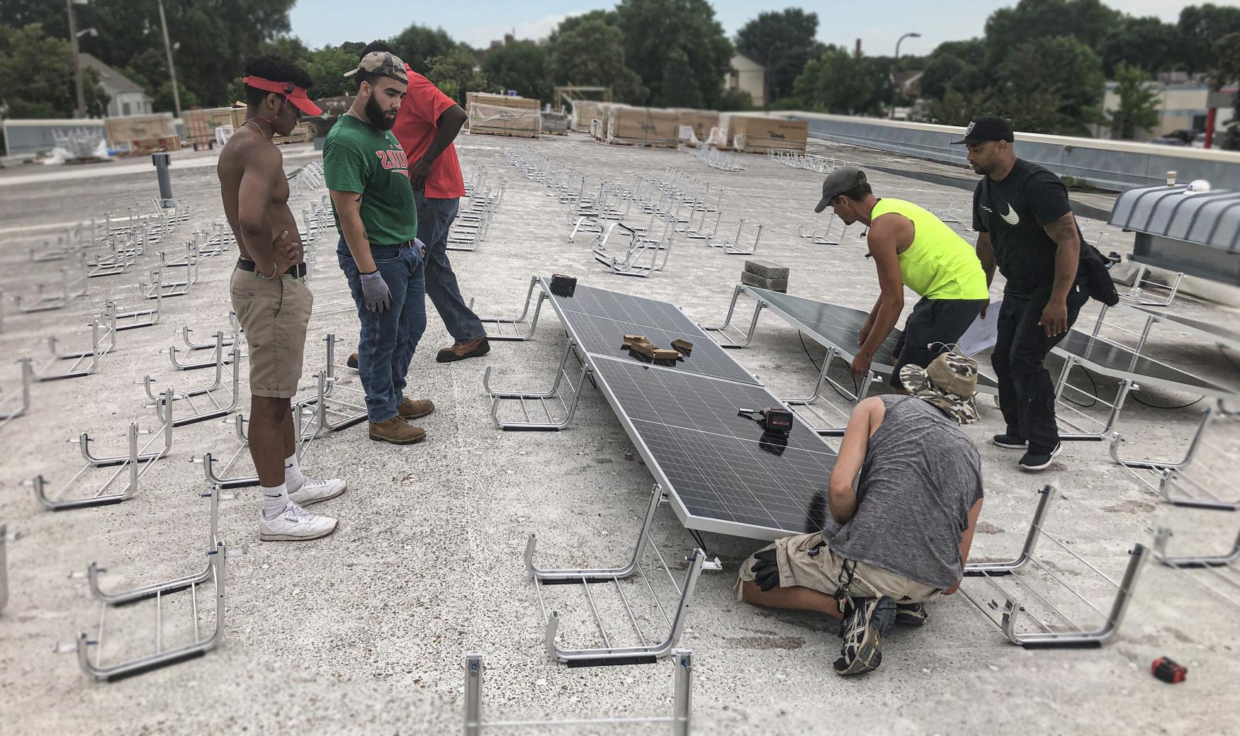 People installing solar panels on a rooftop