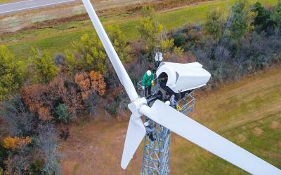 A technician working on a wind turbine